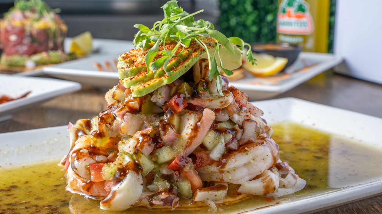 A towering seafood cocktail of shrimp and octopus topped with avocado and chile.