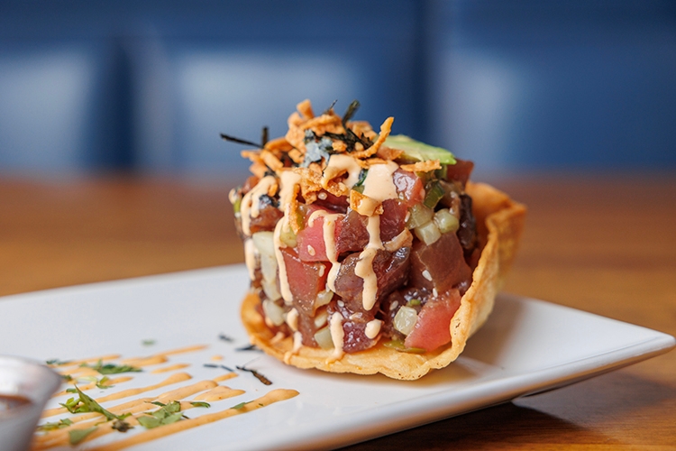 Ahi tuna poke with avocado, crispy onions and nori in a crisp shell.